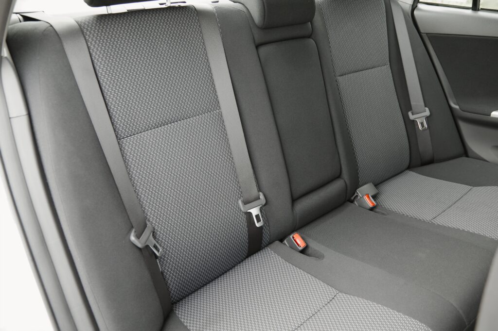 Close up image of clean backseat of car with fabric seats