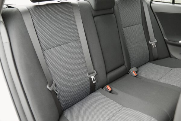 Close up image of clean backseat of car with fabric seats