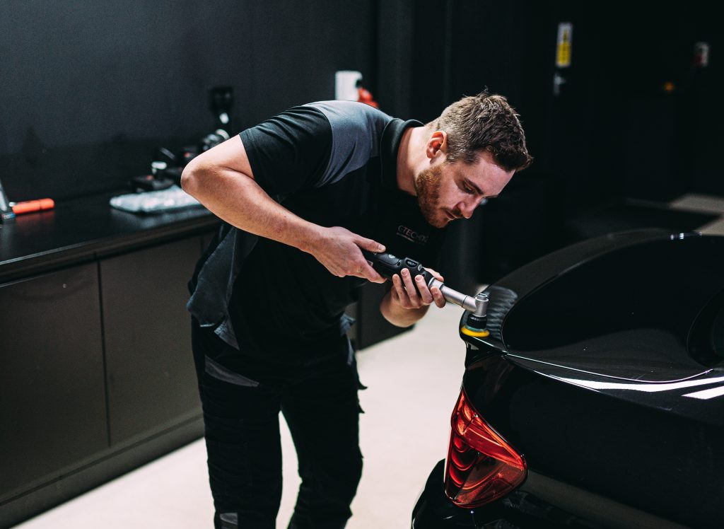 Man correcting paint on a car